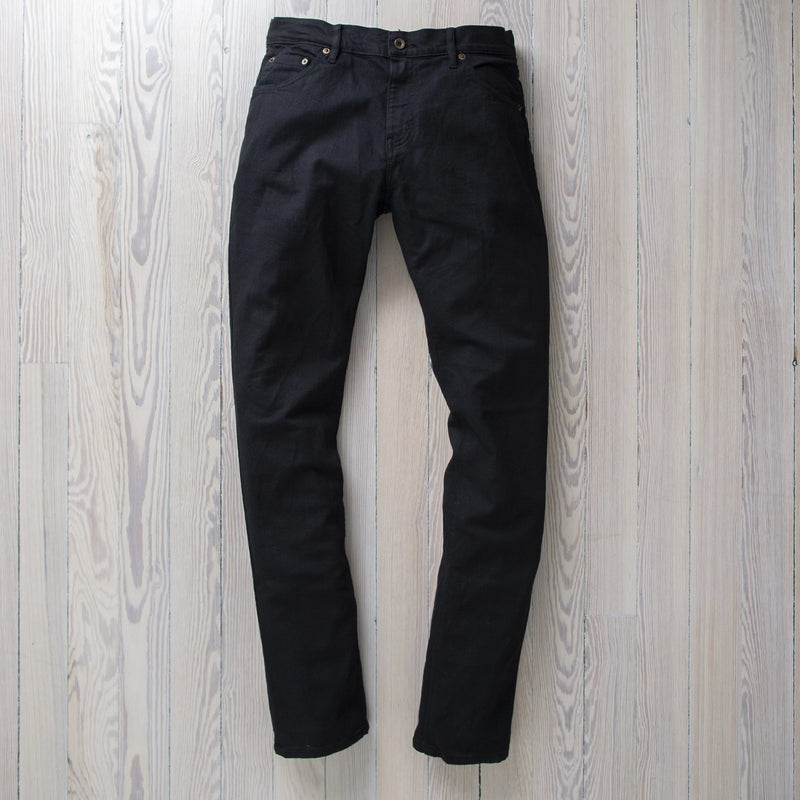 angle: black  Raleigh Denim Workshop Martin thin taper fit stretch pants in black, back