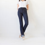 angle: indigo  A model wears Raleigh Denim Workshop Madison high-rise straight leg raw dark jeans, front view