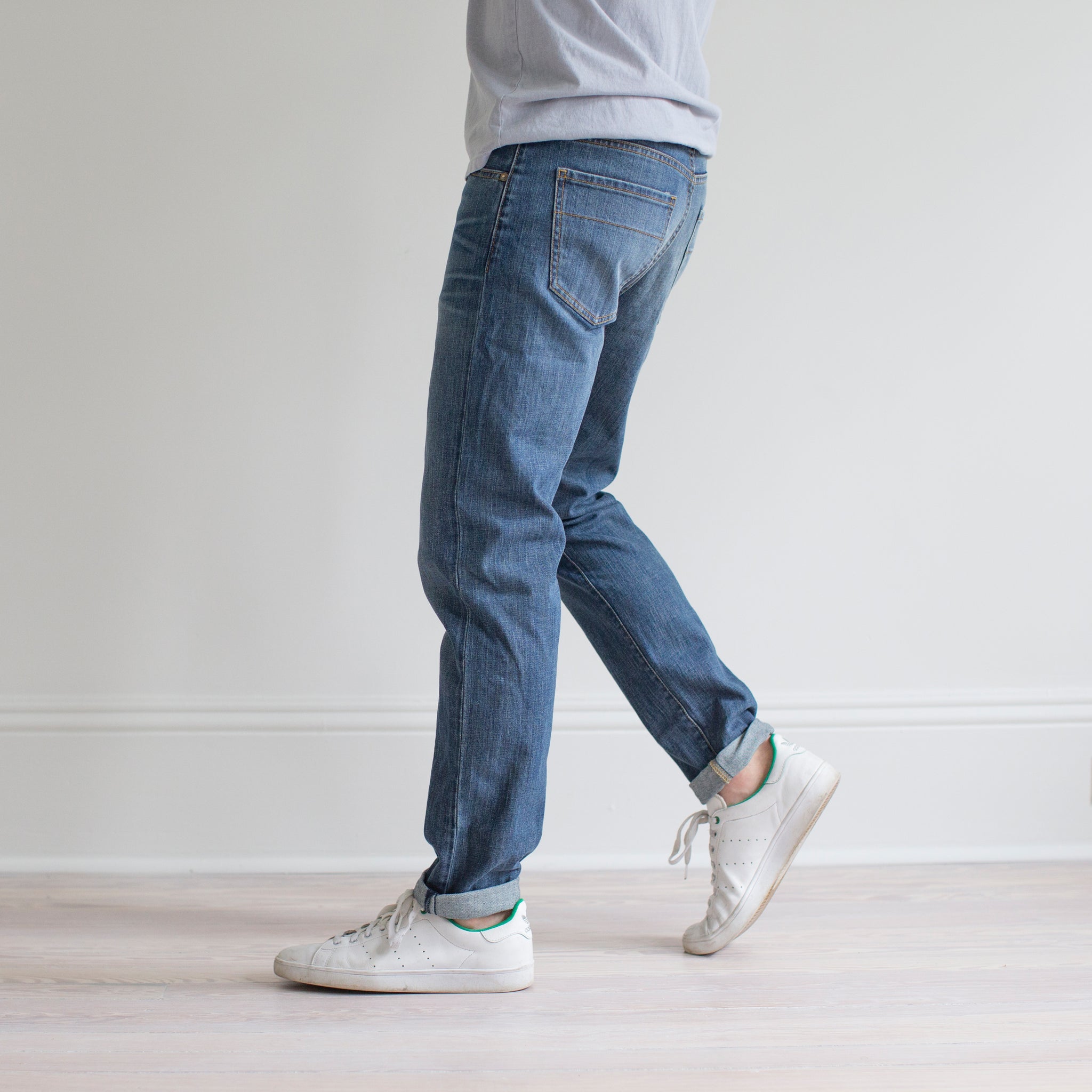 angle hover: pilot  A model wears Raleigh Denim Workshop Graham fit pants in blue, side view