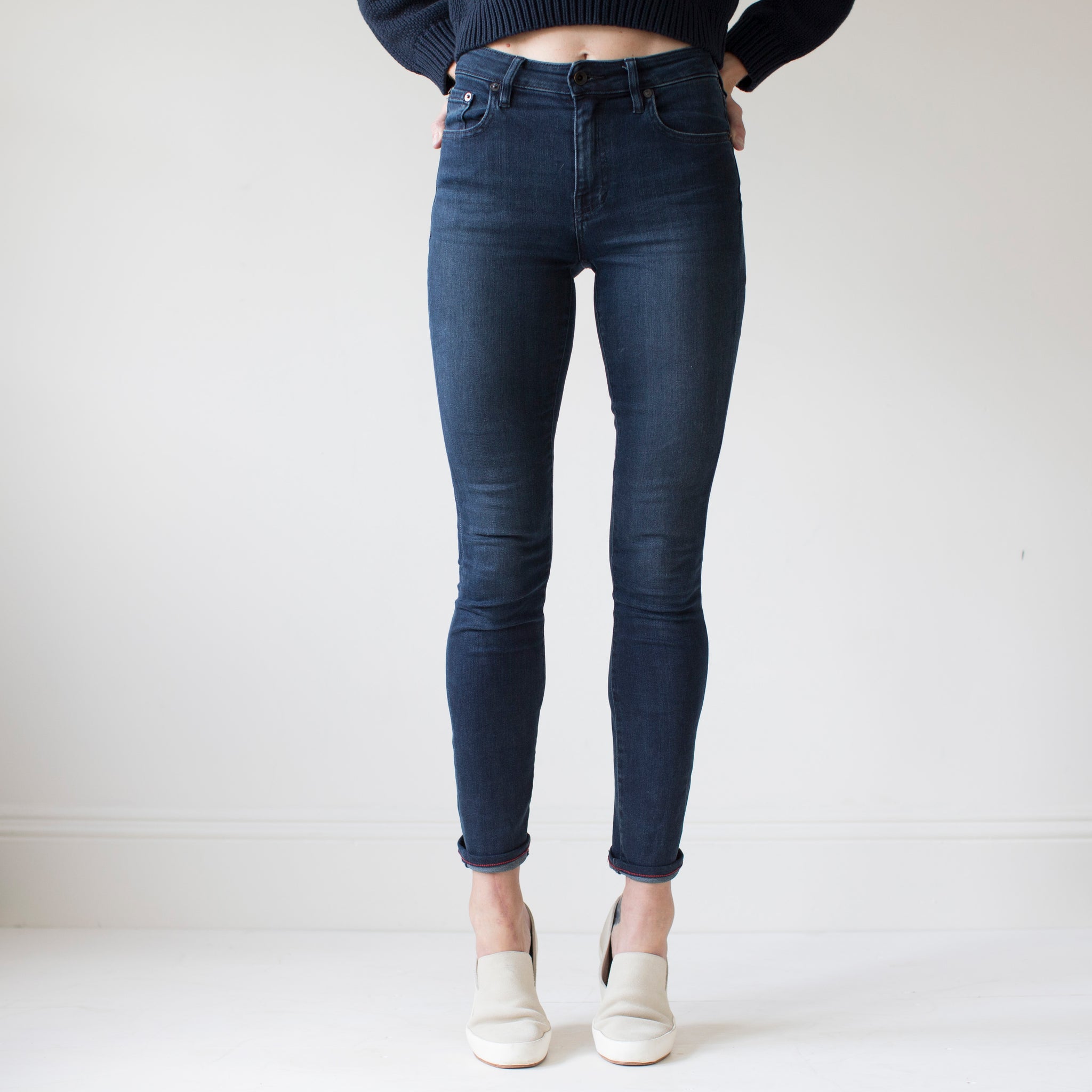 angle: canon  A model wears Raleigh Denim Workshop Haywood high-rise skinny jeans with a dark wash, front view