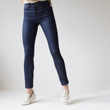 angle: indigo  A model wears Raleigh Denim Workshop Haywood high-rise skinny jeans in dark blue, front view