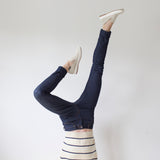 angle: indigo  A model wears Raleigh Denim Workshop Haywood high-rise skinny jeans in dark blue, upside-down view