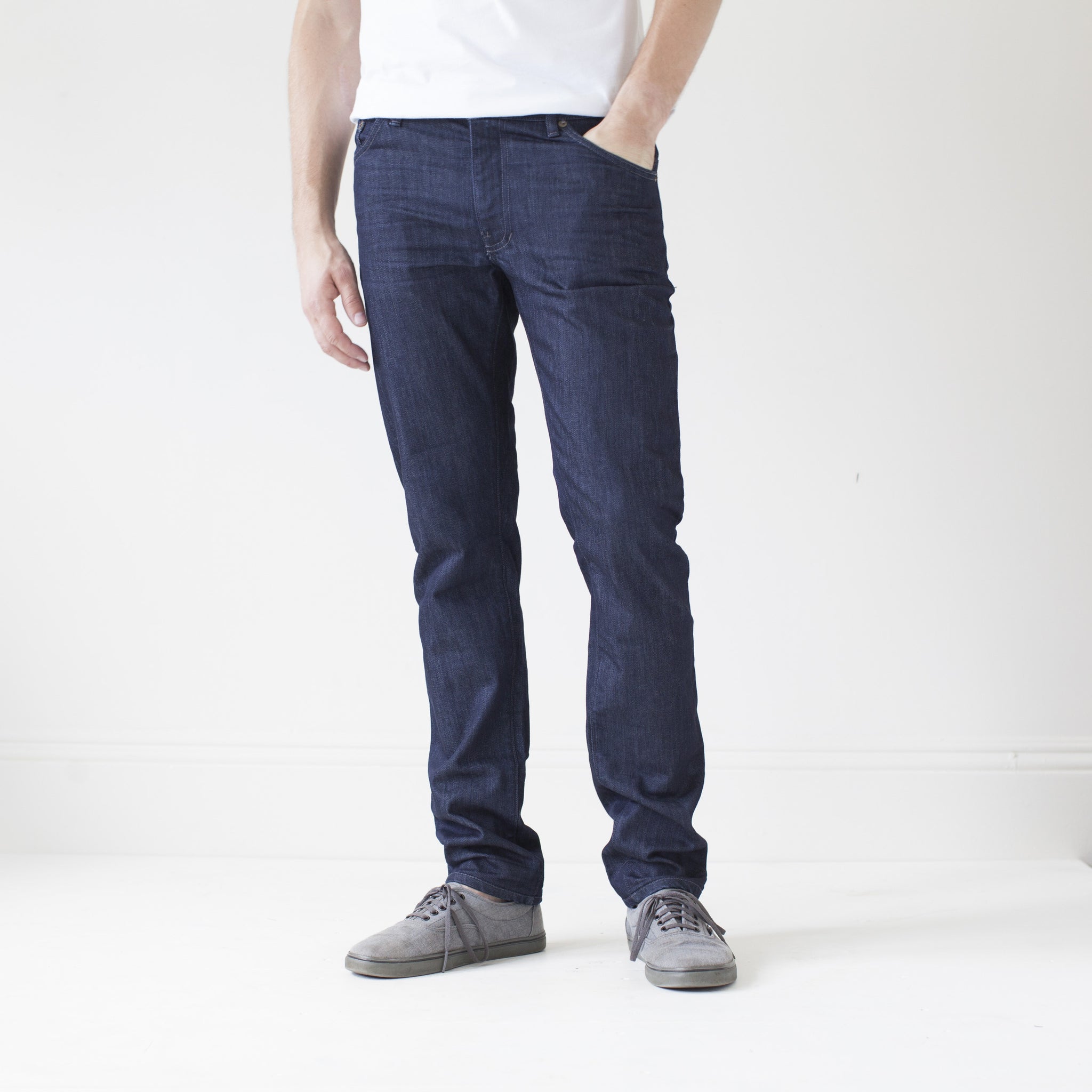 angle: resin rinse  A model wears Raleigh Denim Workshop Jones thin fit in a dark wash, front view