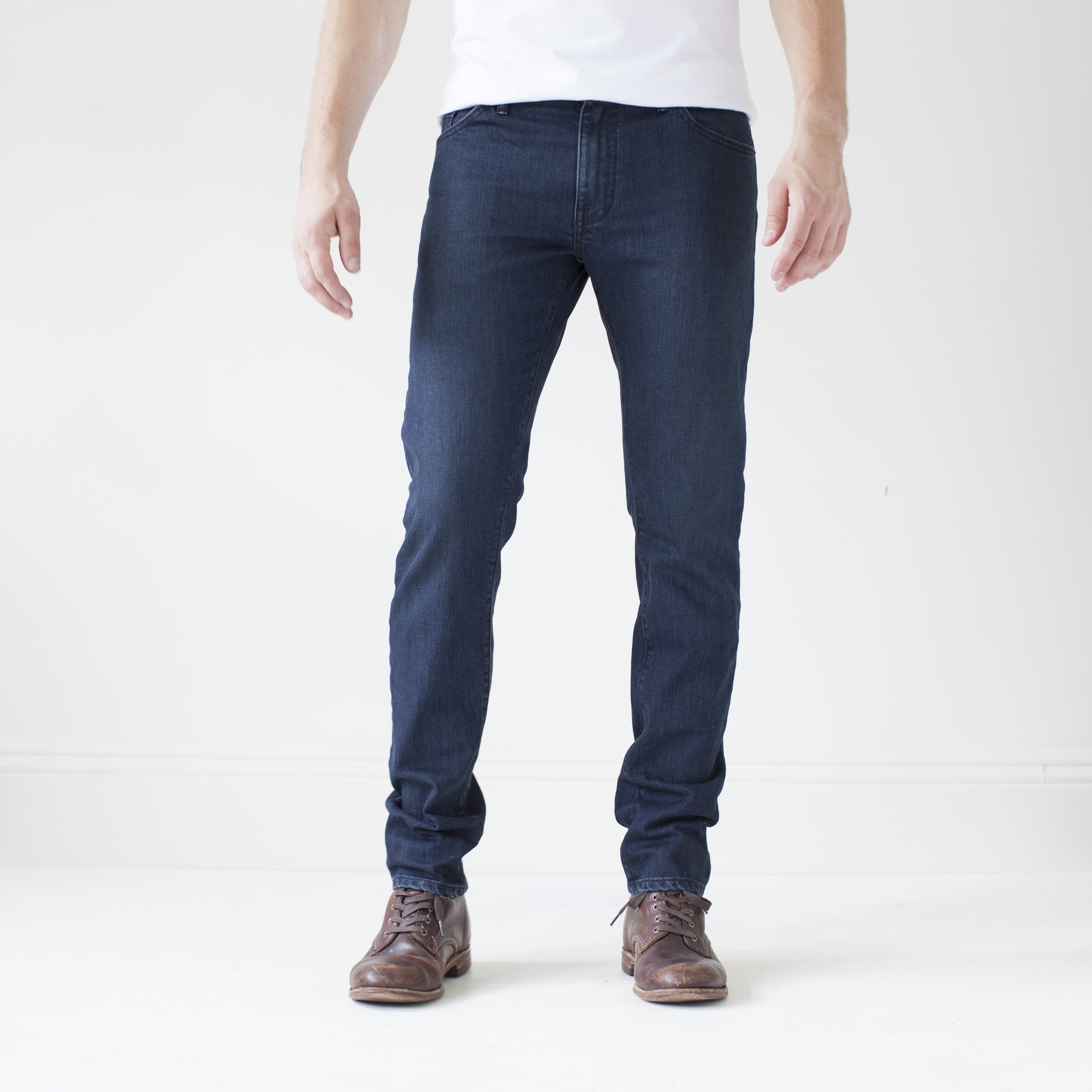 angle: canon  A model wears Raleigh Denim Workshop Martin thin taper fit jeans in original wash, front view