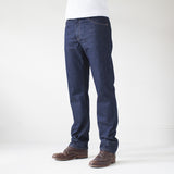 angle: resin rinse  A model wears Raleigh Denim Workshop Alexander work fit jeans with a dark wash, front view