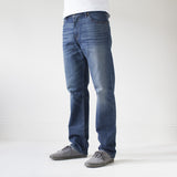 angle: 319  A model wears Raleigh Denim Workshop Alexander work fit jeans in the 319 wash, side view