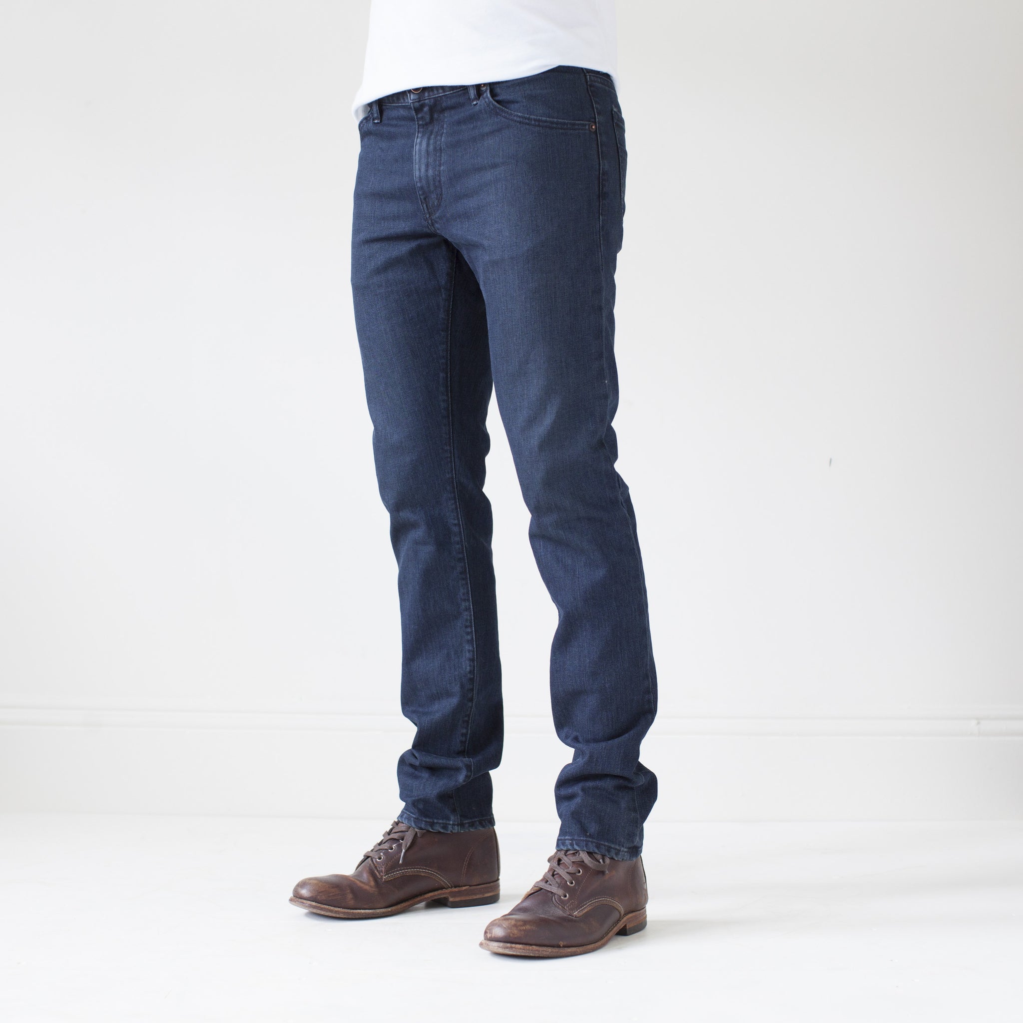 angle: canon  A model wears Raleigh Denim Workshop Martin thin taper fit jeans in original wash, side view